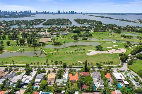 an aerial view of residential houses with outdoor space and seating area