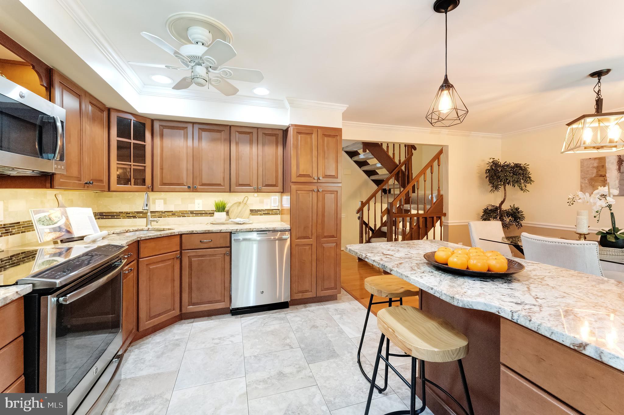 1512 Poplar Grove Drive Reston, VA 20194 - Photo 11 of 70 a kitchen with stainless steel appliances granite countertop a sink a stove and a wooden cabinets