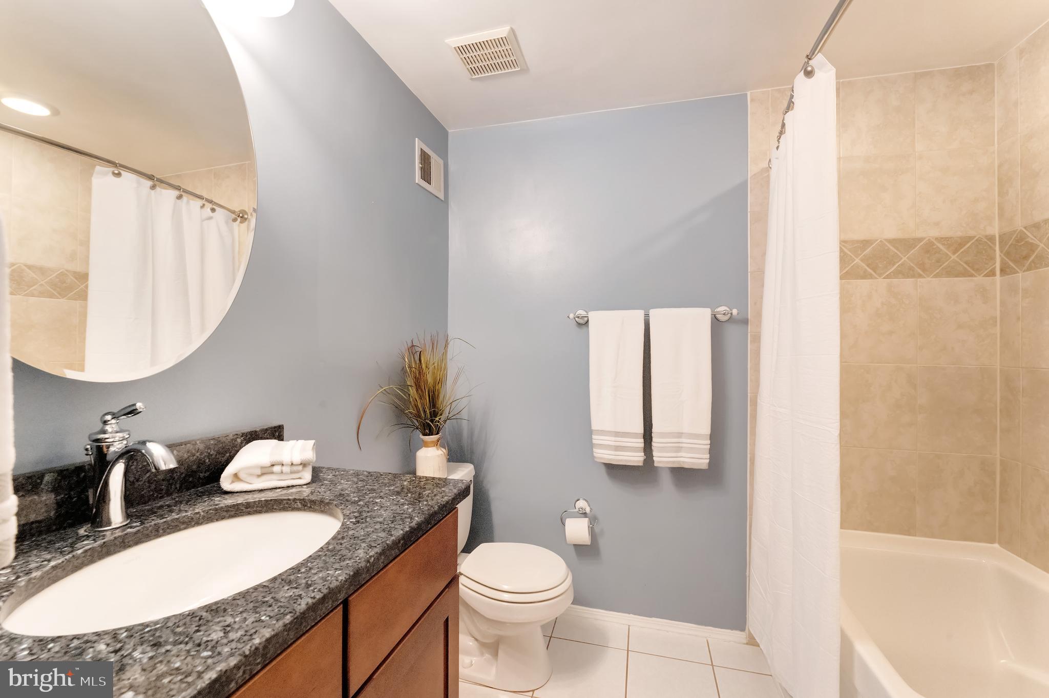 1512 Poplar Grove Drive Reston, VA 20194 - Photo 22 of 70 a bathroom with a granite countertop sink toilet and a mirror
