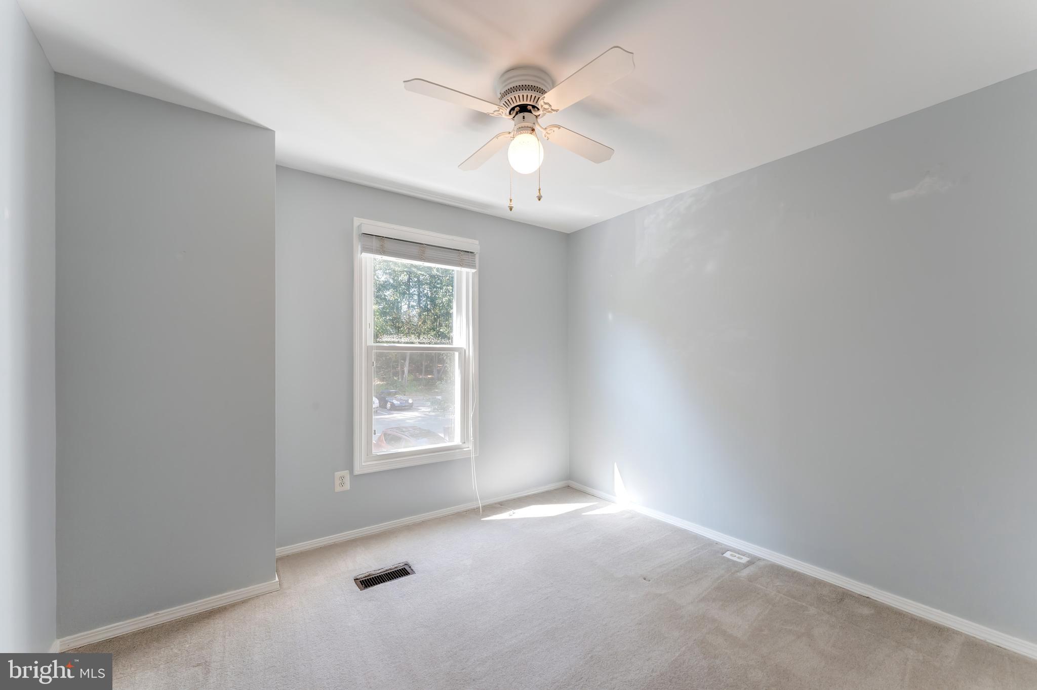 1512 Poplar Grove Drive Reston, VA 20194 - Photo 23 of 70 an empty room with a window and a ceiling fan