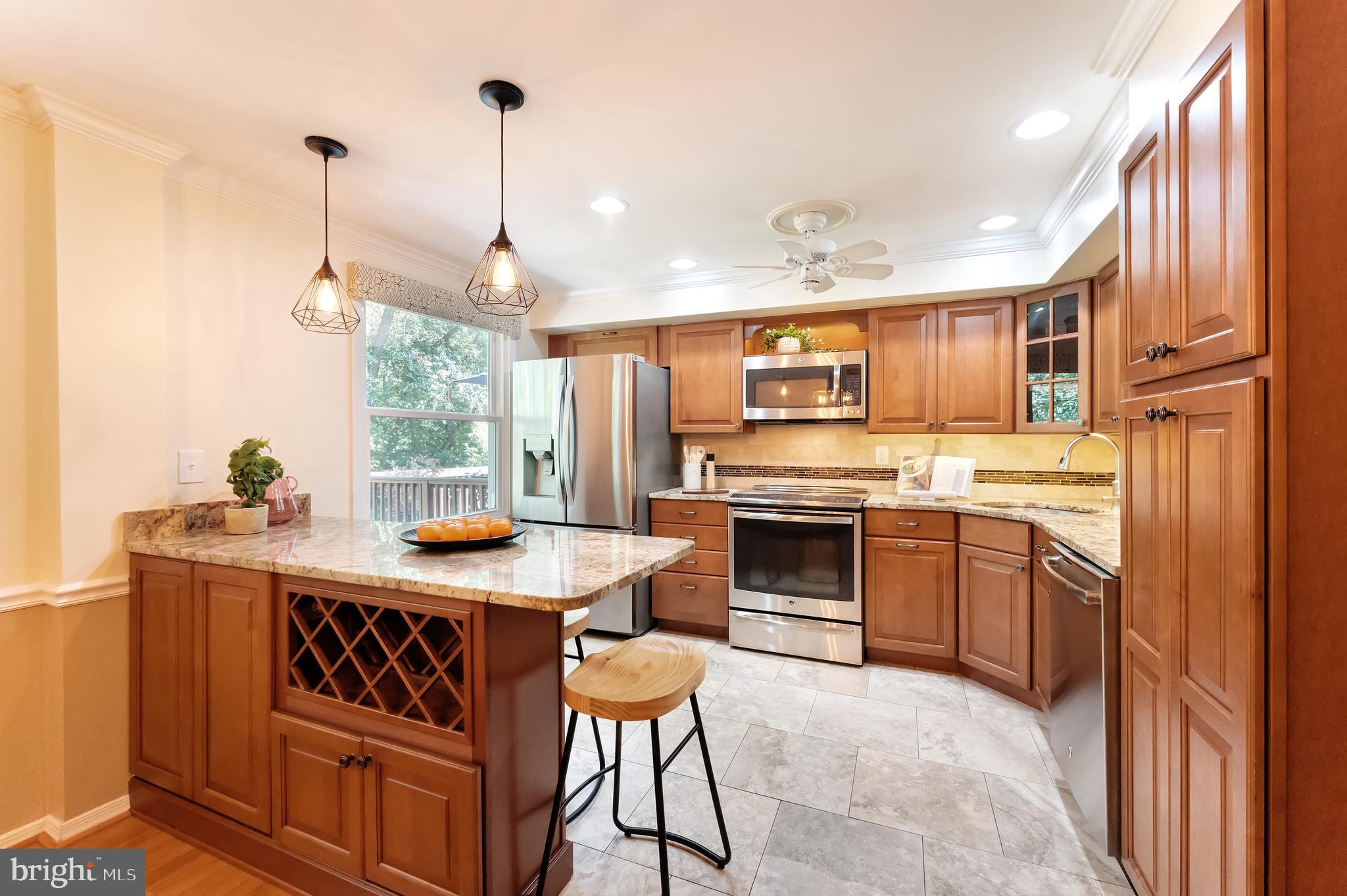 1512 Poplar Grove Drive Reston, VA 20194 - Photo 9 of 70 a kitchen with stainless steel appliances granite countertop a stove refrigerator sink and cabinets