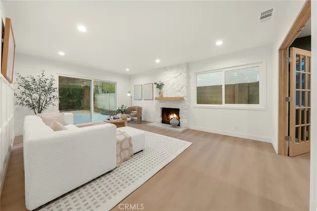 a living room with furniture a fireplace and a table