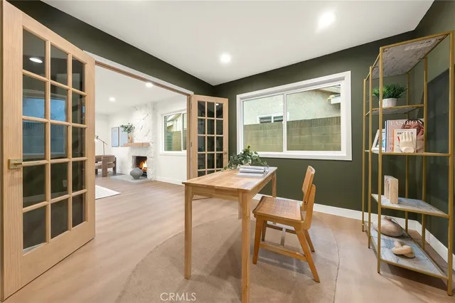 a dining room with furniture and a floor to ceiling window