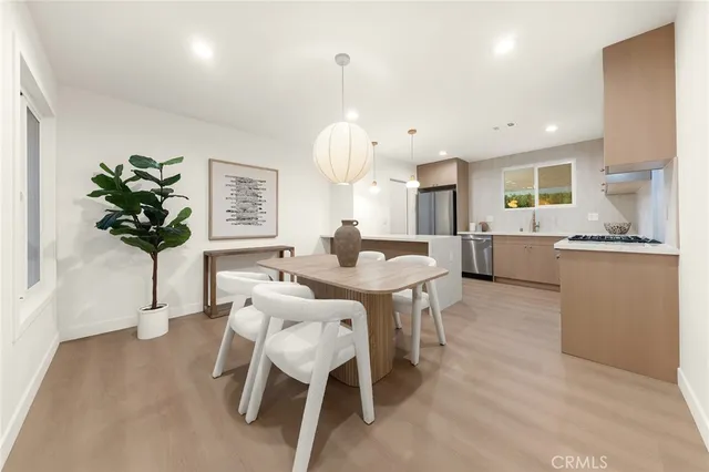 a living room with kitchen island furniture and a chandelier