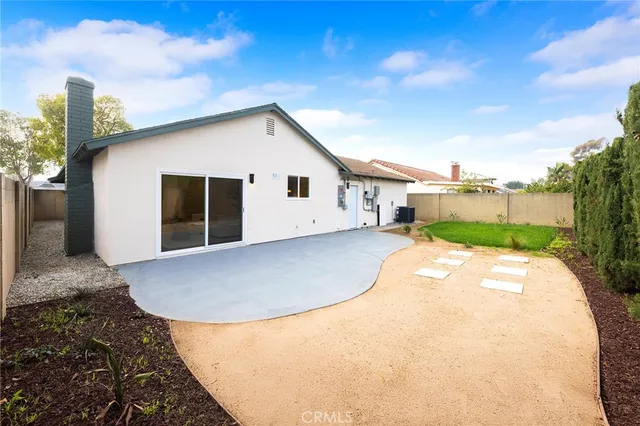 a view of a house with a backyard