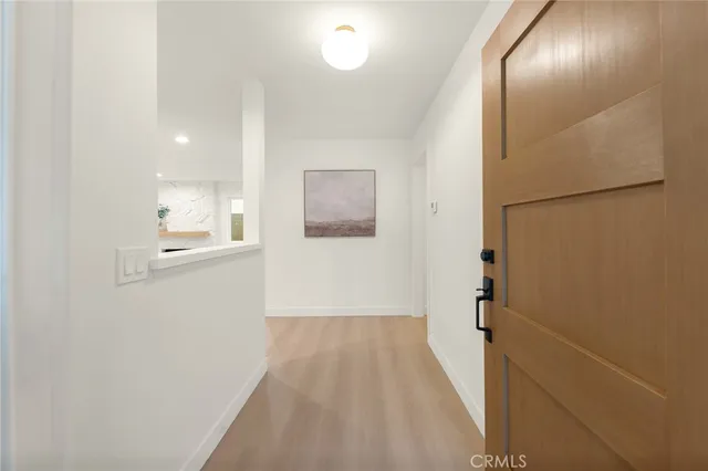 a view of a hallway with wooden floor