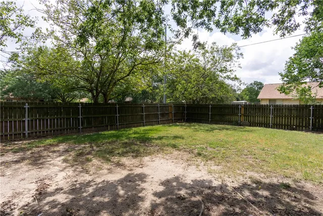 a backyard of a house with trampoline