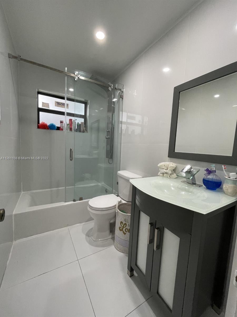 Kendale Lakes Miami, FL 33183 - Photo 14 of 26 a bathroom with a sink a toilet a mirror and bathtub