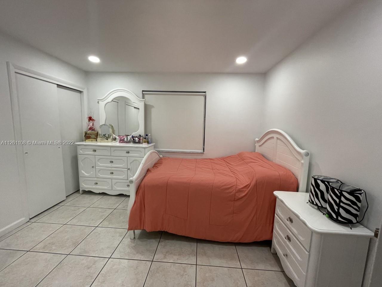 Kendale Lakes Miami, FL 33183 - Photo 16 of 26 a bedroom with a bed and a dresser