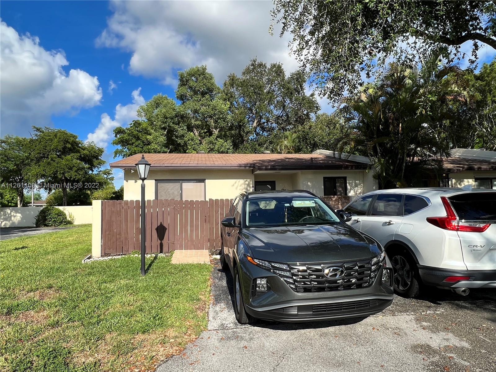 Kendale Lakes Miami, FL 33183 - Photo 3 of 26 a front view of a house with a garden