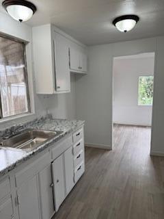 681 South Market Road Earlimart, CA 93219 - Photo 10 of 13 a kitchen with granite countertop a stove a sink and a microwave
