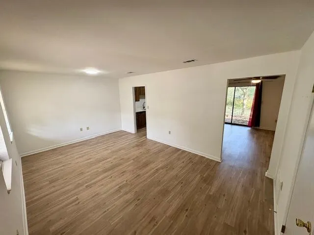 wooden floor in an empty room with a window