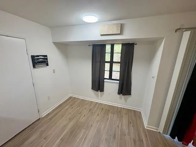 wooden floor in an empty room with a window