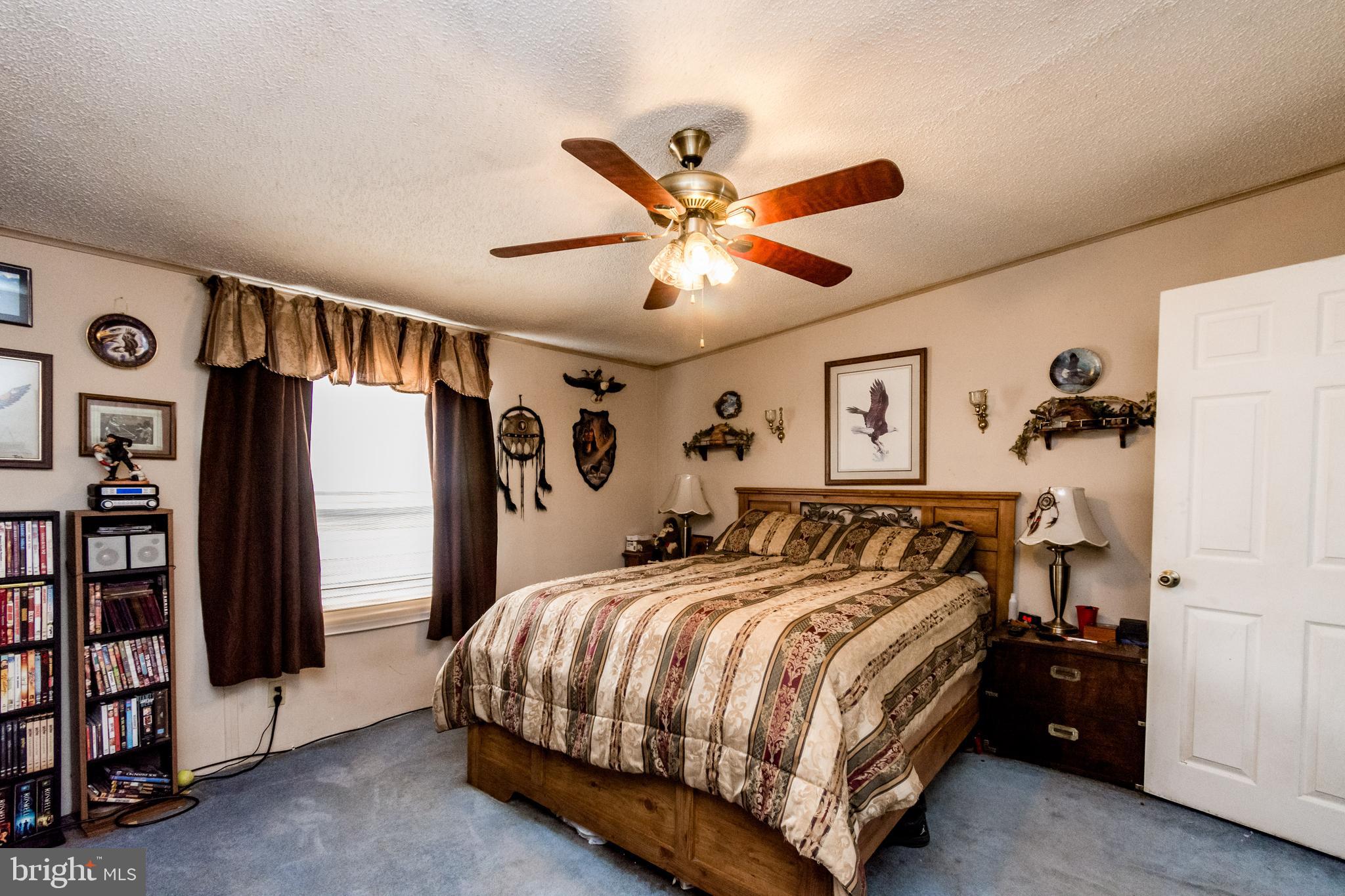2293 Fords Corner Road Hartly, DE 19953 - Photo 30 of 47 a bedroom with bed and a chandelier
