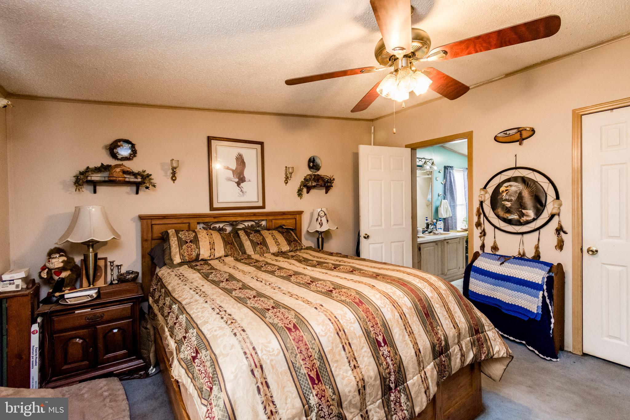 2293 Fords Corner Road Hartly, DE 19953 - Photo 32 of 47 a bedroom with a bed and a chandelier