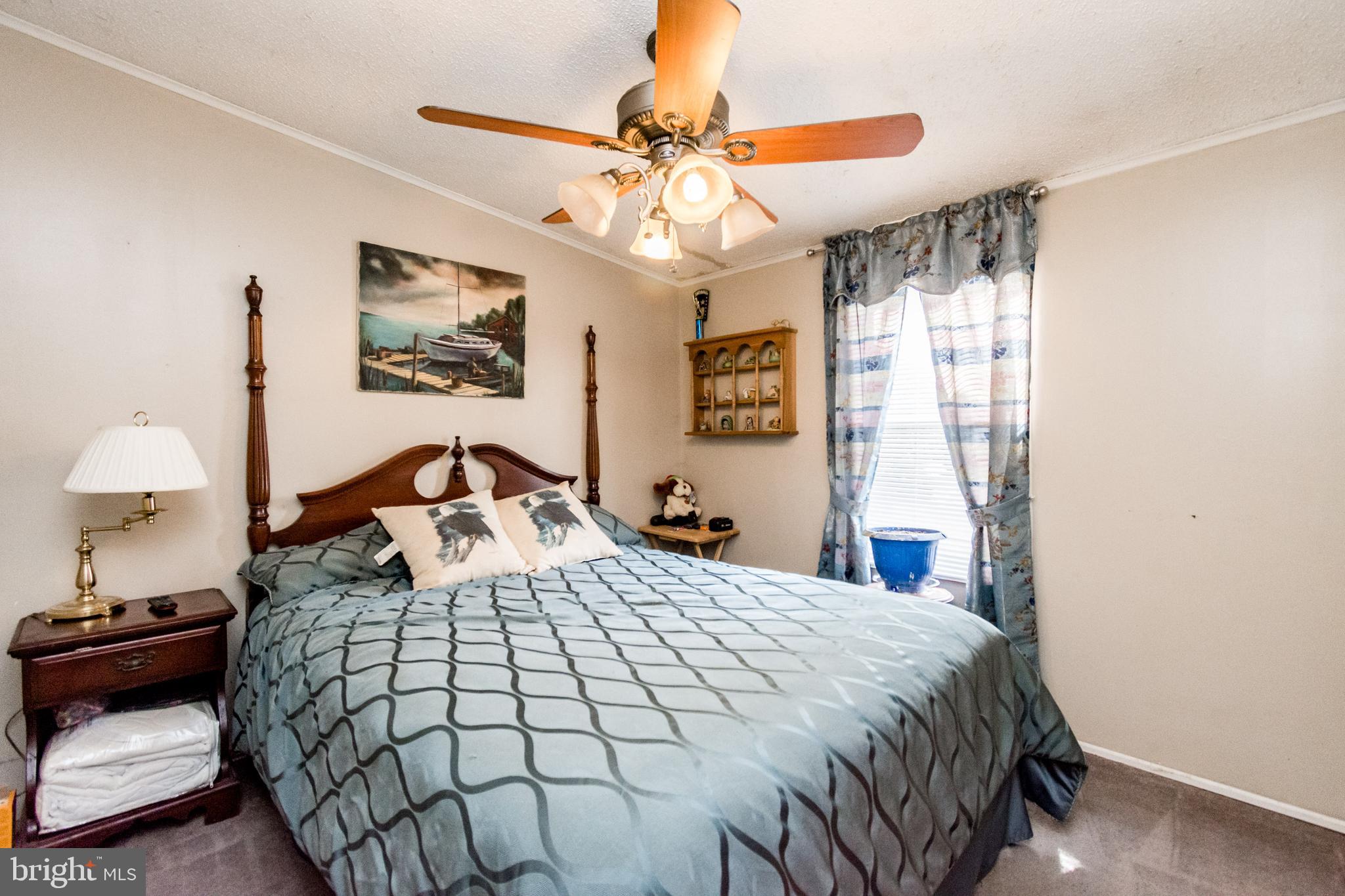 2293 Fords Corner Road Hartly, DE 19953 - Photo 44 of 47 a bedroom with a bed and a chandelier