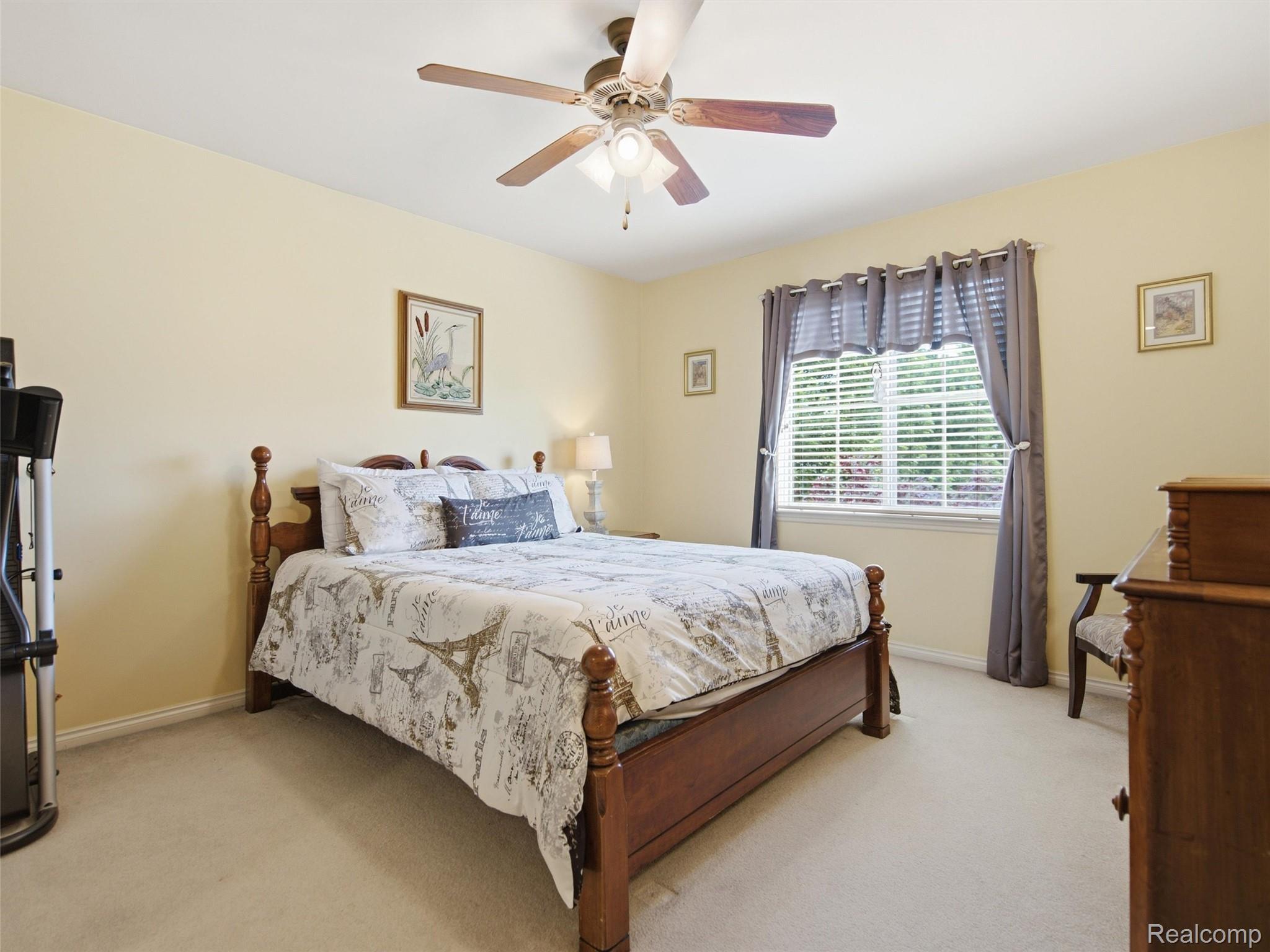 2633 Ridgecrest Drive Utica, MI 48316 - Photo 16 of 28 Third Bedroom featuring a ceiling fan, carpeting and large window.