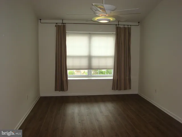 a view of staircase with wooden floor and a window
