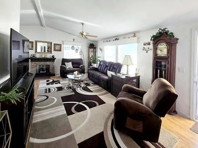 a living room with furniture a fireplace and a window