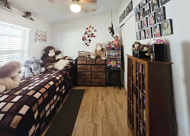 a bed room with a bed and a book shelf