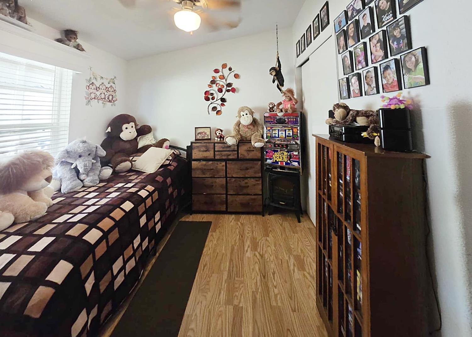 18717 Mill Villa Road, Unit 615 Jamestown, CA 95327 - Photo 19 of 19 a bed room with a bed and a book shelf