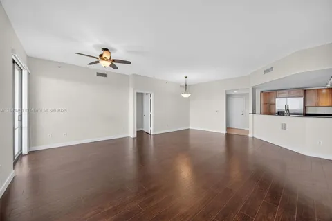 a view of a kitchen with a sink and wooden floor