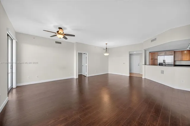 a view of a kitchen with a sink and wooden floor