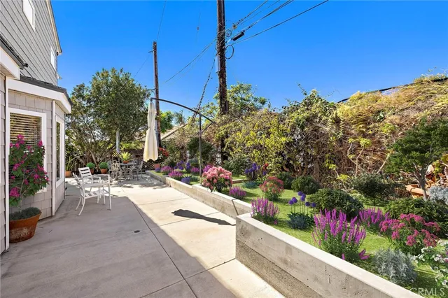 a view of a chairs and table in backyard
