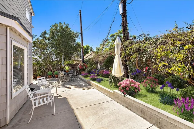 a kitchen with white cabinets and chairs