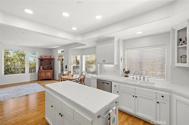 a bedroom with a bed and large windows