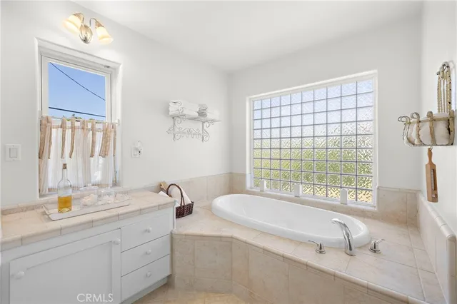 a spacious bathroom with a double vanity sink a mirror and a shower