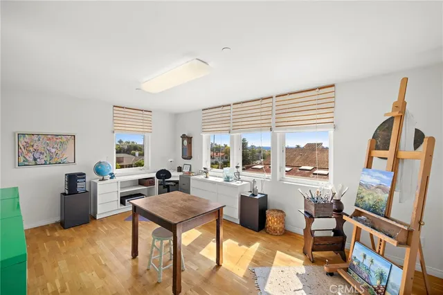 a room with furniture a large window and a wooden floor