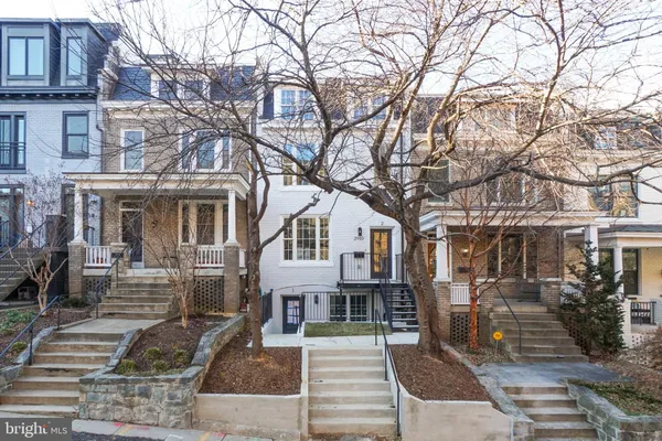 a front view of a building with trees