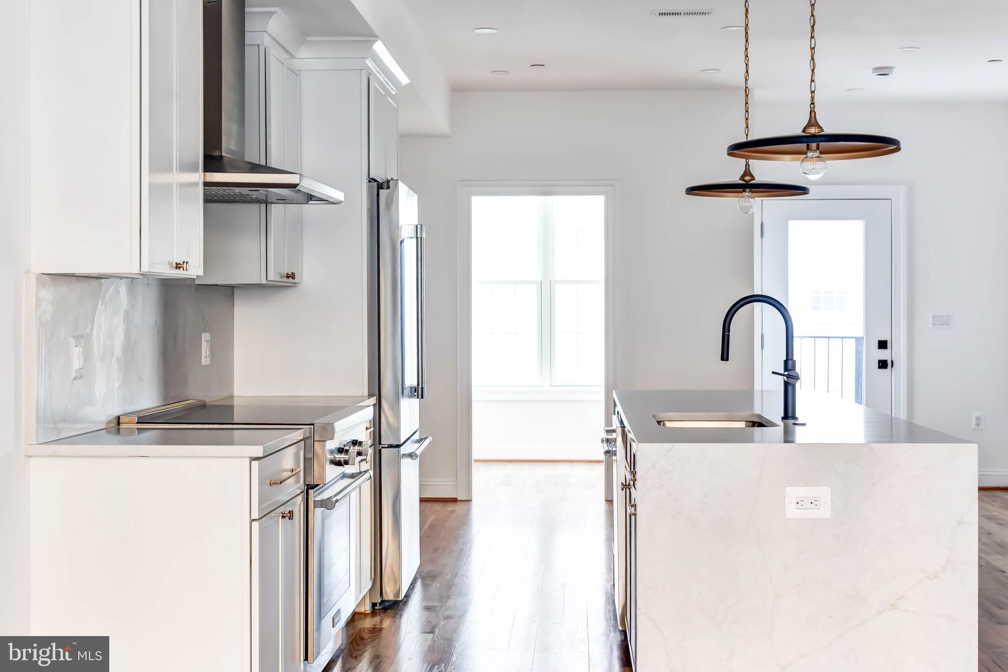 2910 18th Street Northwest Washington, DC 20009 - Photo 11 of 54 a kitchen with stainless steel appliances a sink a stove and a refrigerator