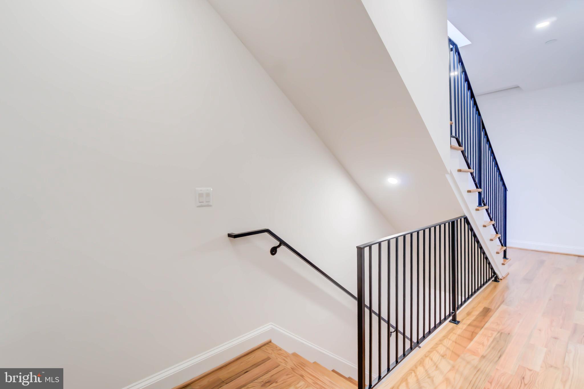 2910 18th Street Northwest Washington, DC 20009 - Photo 19 of 54 a view of a hallway with wooden floor and stairs