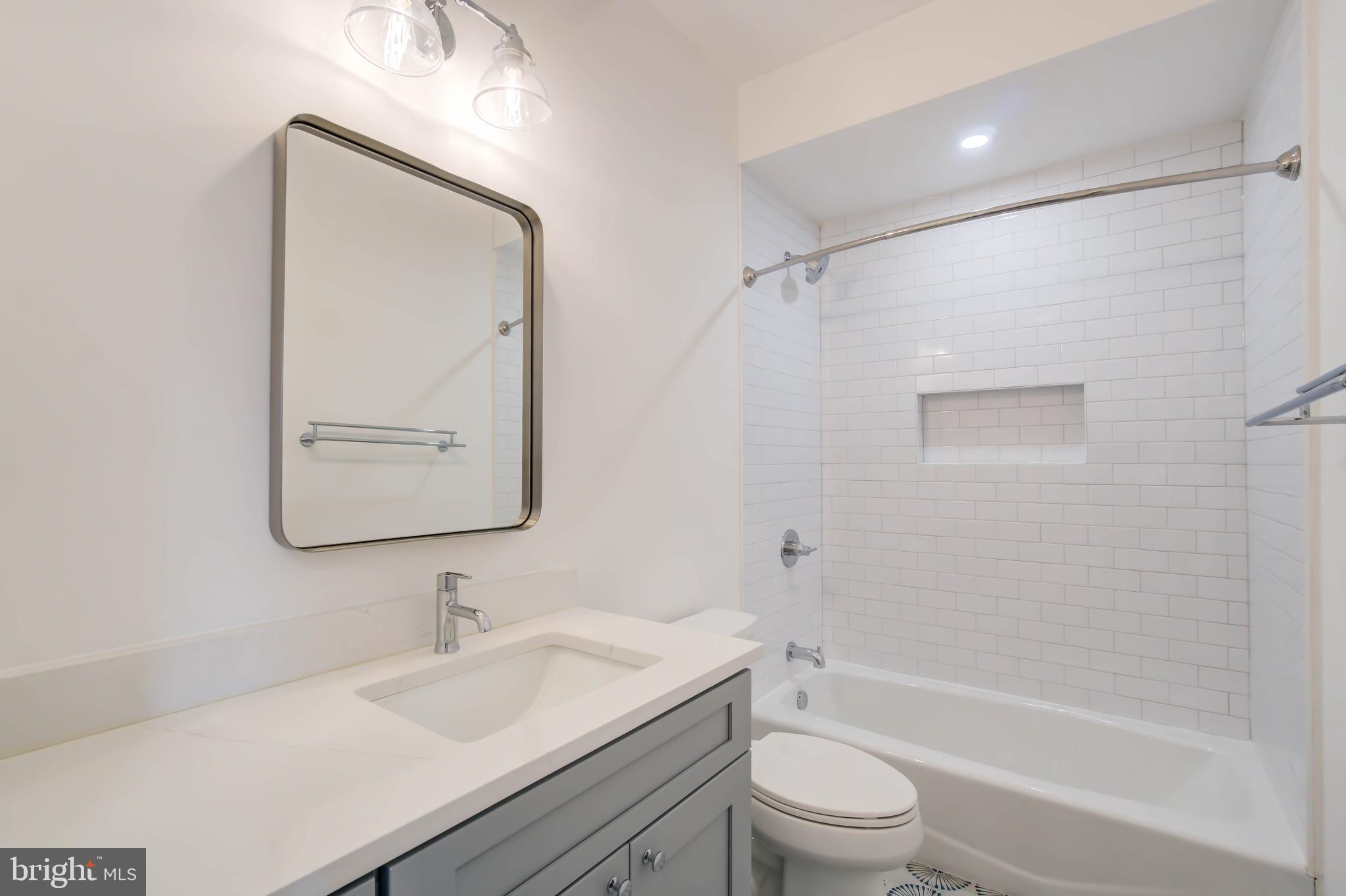 2910 18th Street Northwest Washington, DC 20009 - Photo 33 of 54 a bathroom with a granite countertop sink toilet a mirror and shower