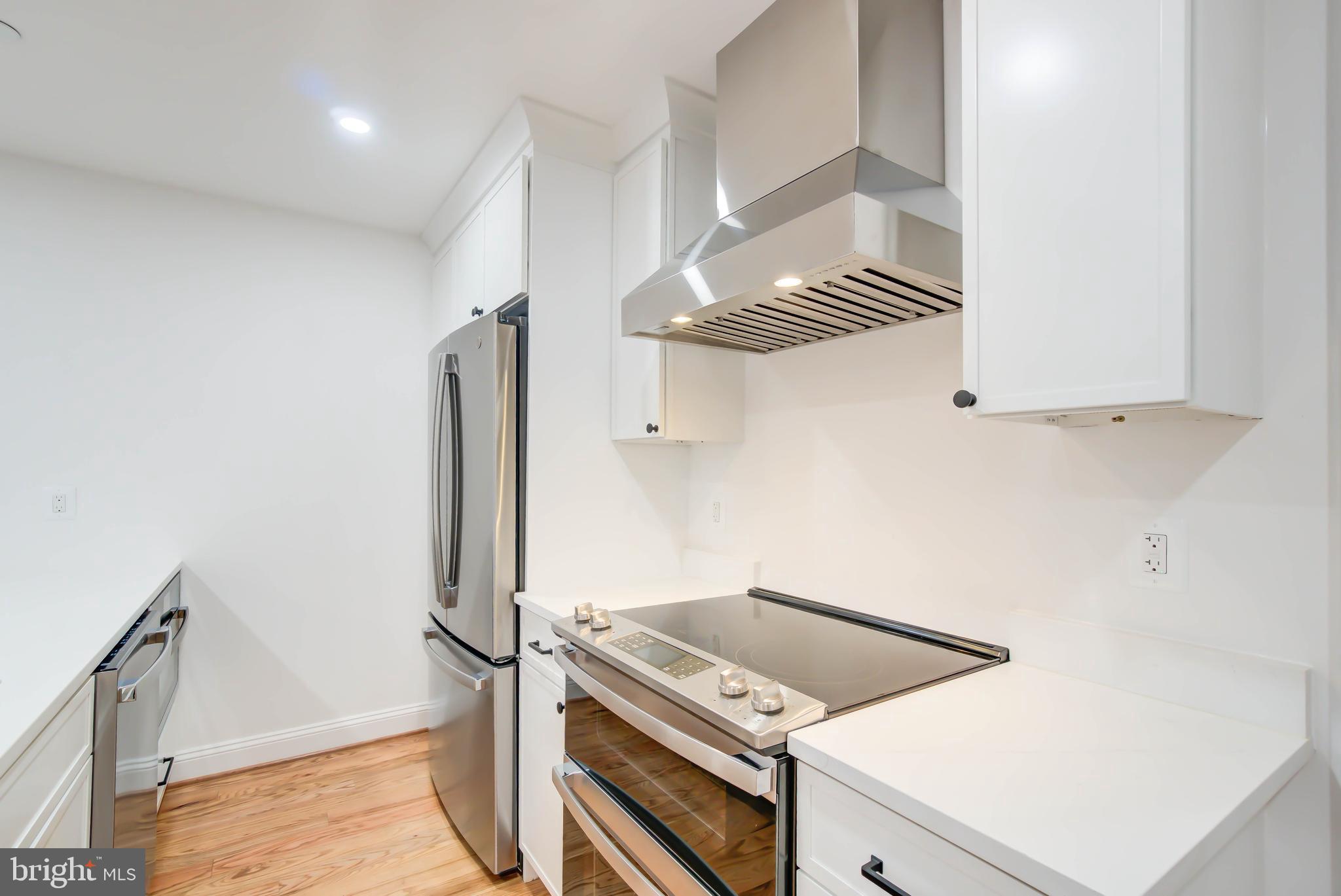 2910 18th Street Northwest Washington, DC 20009 - Photo 43 of 54 a kitchen with cabinets and a stove