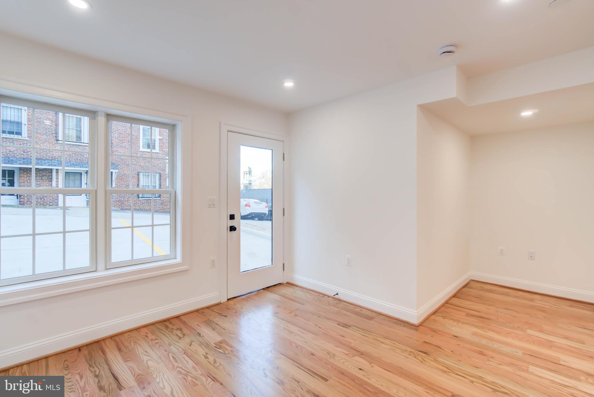 2910 18th Street Northwest Washington, DC 20009 - Photo 49 of 54 a view of an empty room with wooden floor and windows