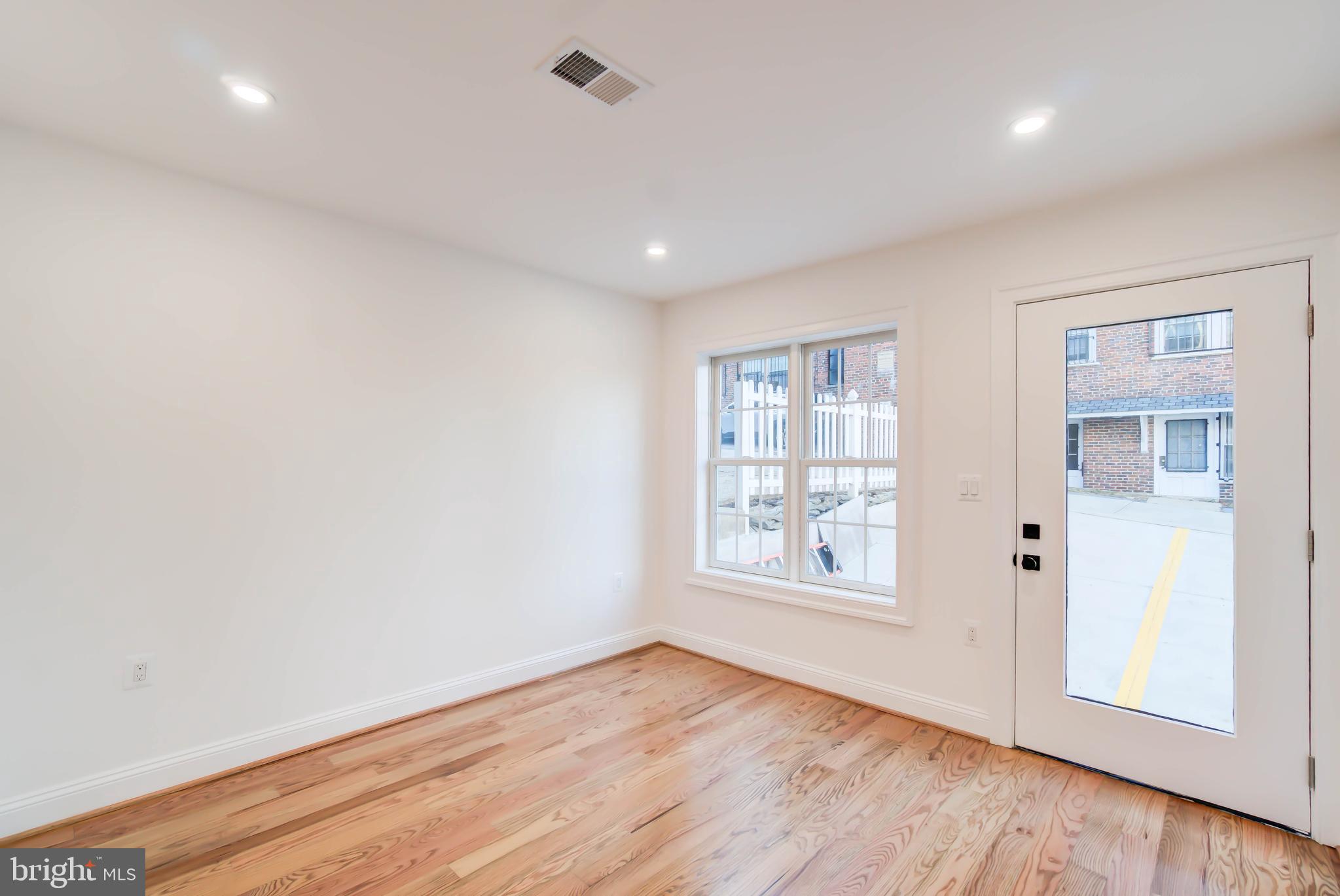 2910 18th Street Northwest Washington, DC 20009 - Photo 50 of 54 an empty room with wooden floor and windows