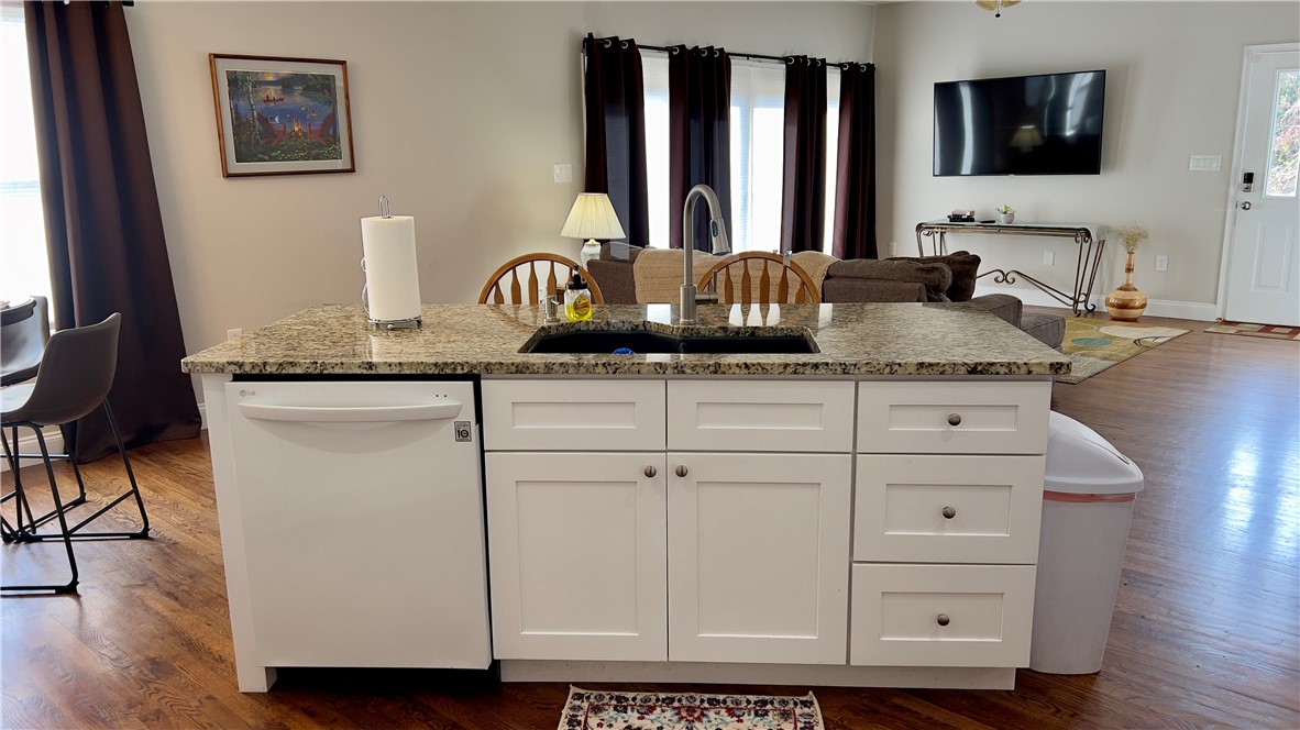 160 Hudgins Lake Road Townville, SC 29689 - Photo 35 of 41 An inviting open-concept kitchen features a large island with granite counters and a dishwasher, perfect for casual dining and entertaining.