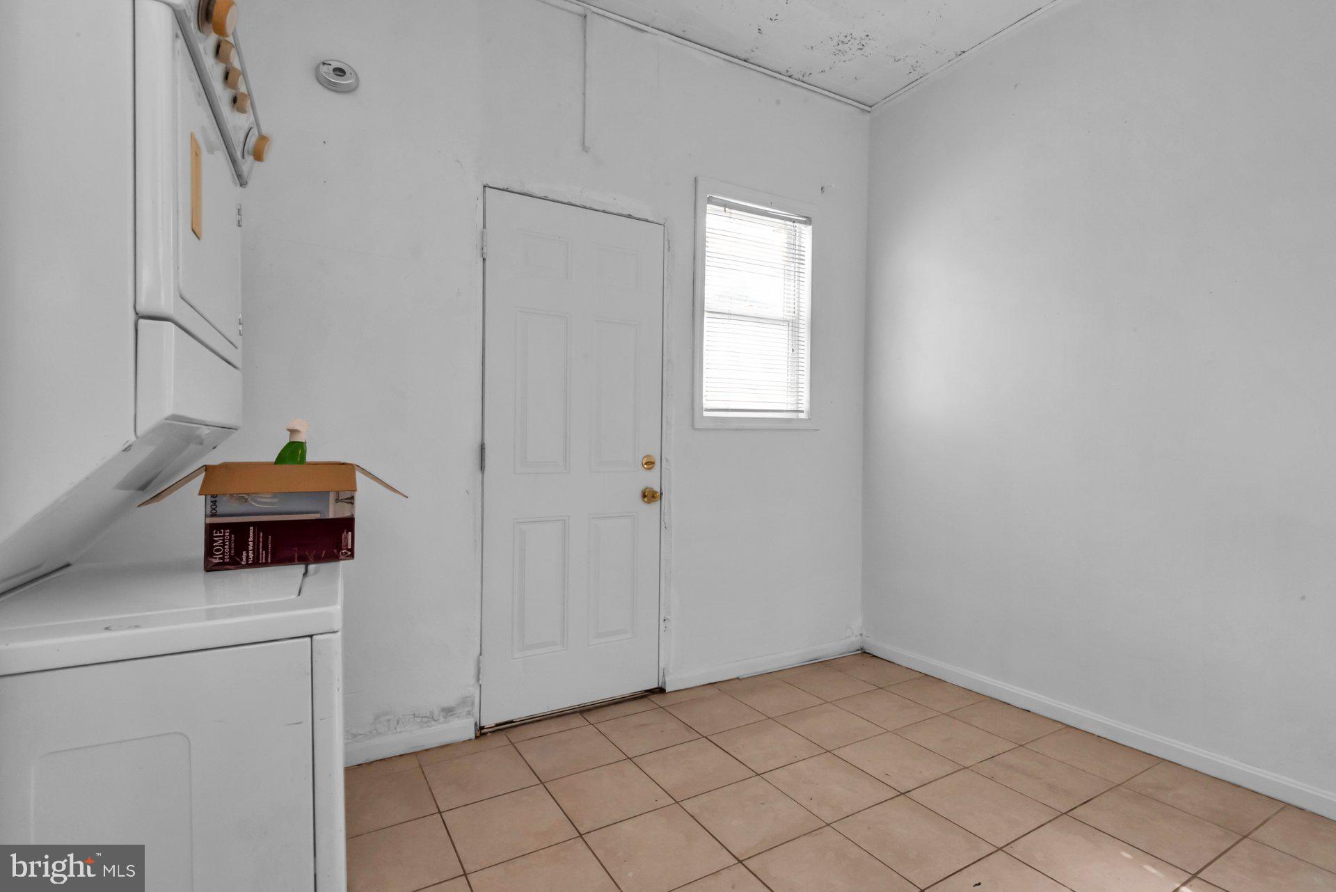 1016 Irving Street Northwest Washington, DC 20010 - Photo 18 of 37 a view of storage and utility room with washer and dryer