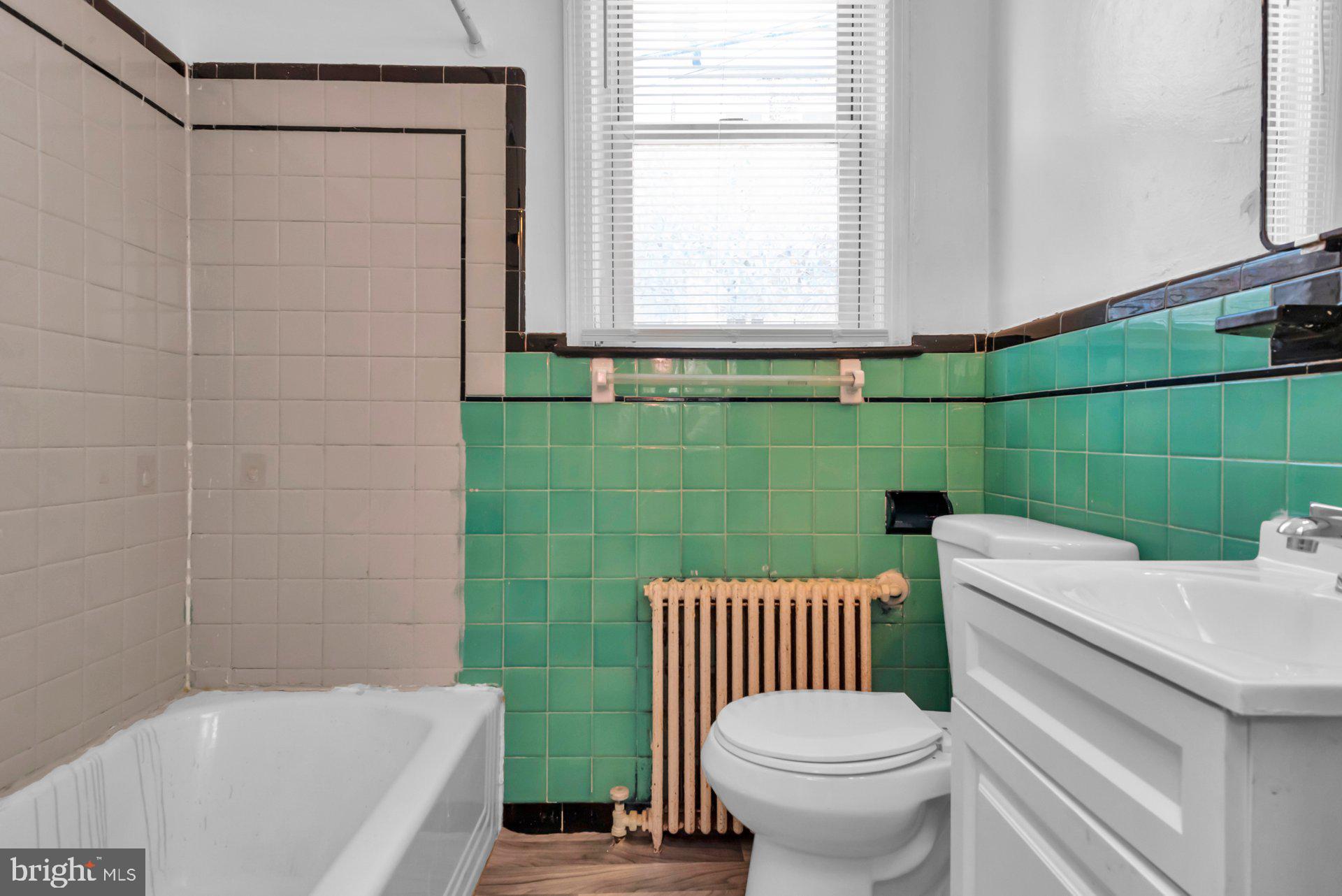 1016 Irving Street Northwest Washington, DC 20010 - Photo 19 of 37 a bathroom with a sink a toilet and bathtub