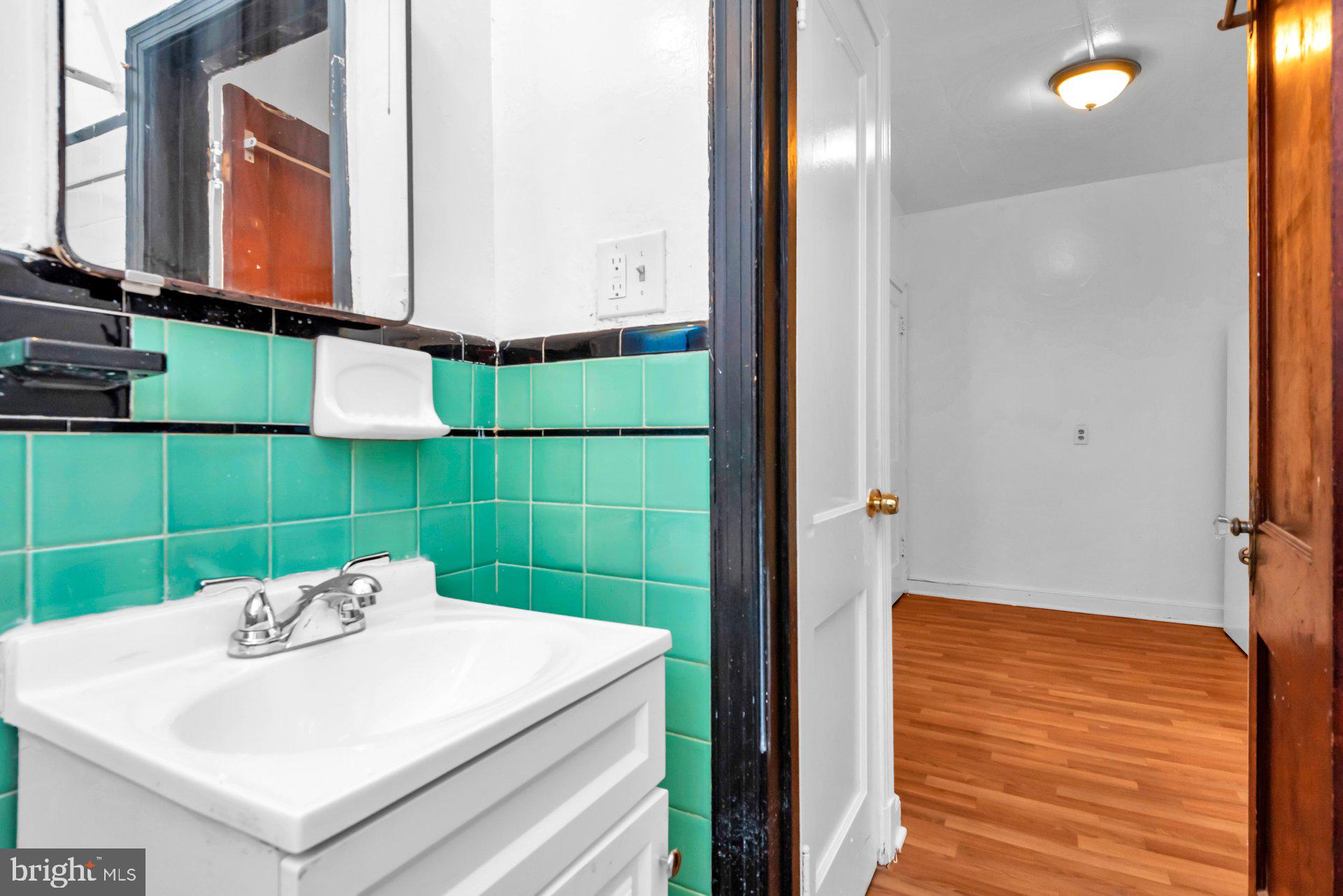 1016 Irving Street Northwest Washington, DC 20010 - Photo 20 of 37 a bathroom with a sink and a mirror