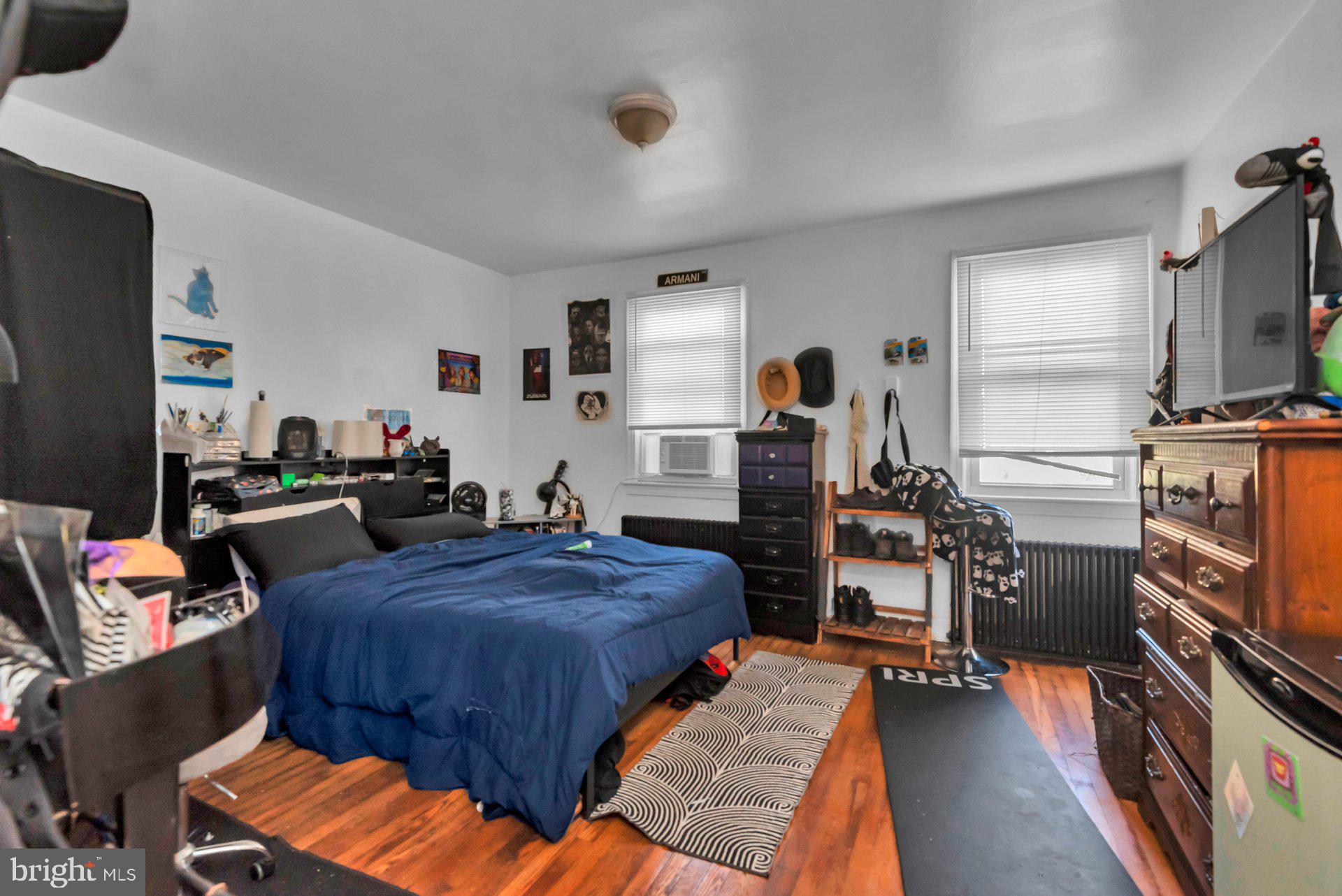 1016 Irving Street Northwest Washington, DC 20010 - Photo 22 of 37 a bedroom with furniture and a flat screen tv