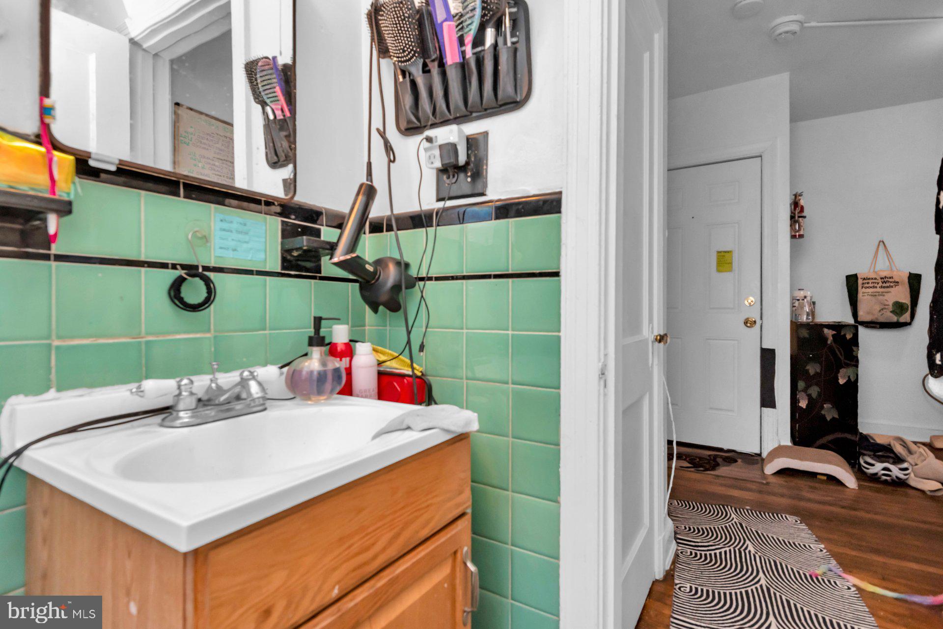 1016 Irving Street Northwest Washington, DC 20010 - Photo 27 of 37 a bathroom with a sink and a mirror