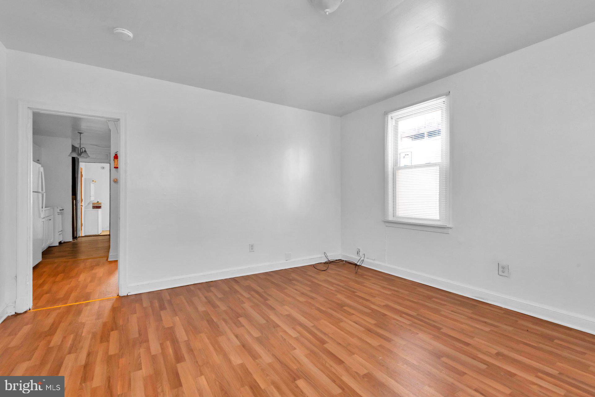 1016 Irving Street Northwest Washington, DC 20010 - Photo 4 of 37 an empty room with wooden floor and closet