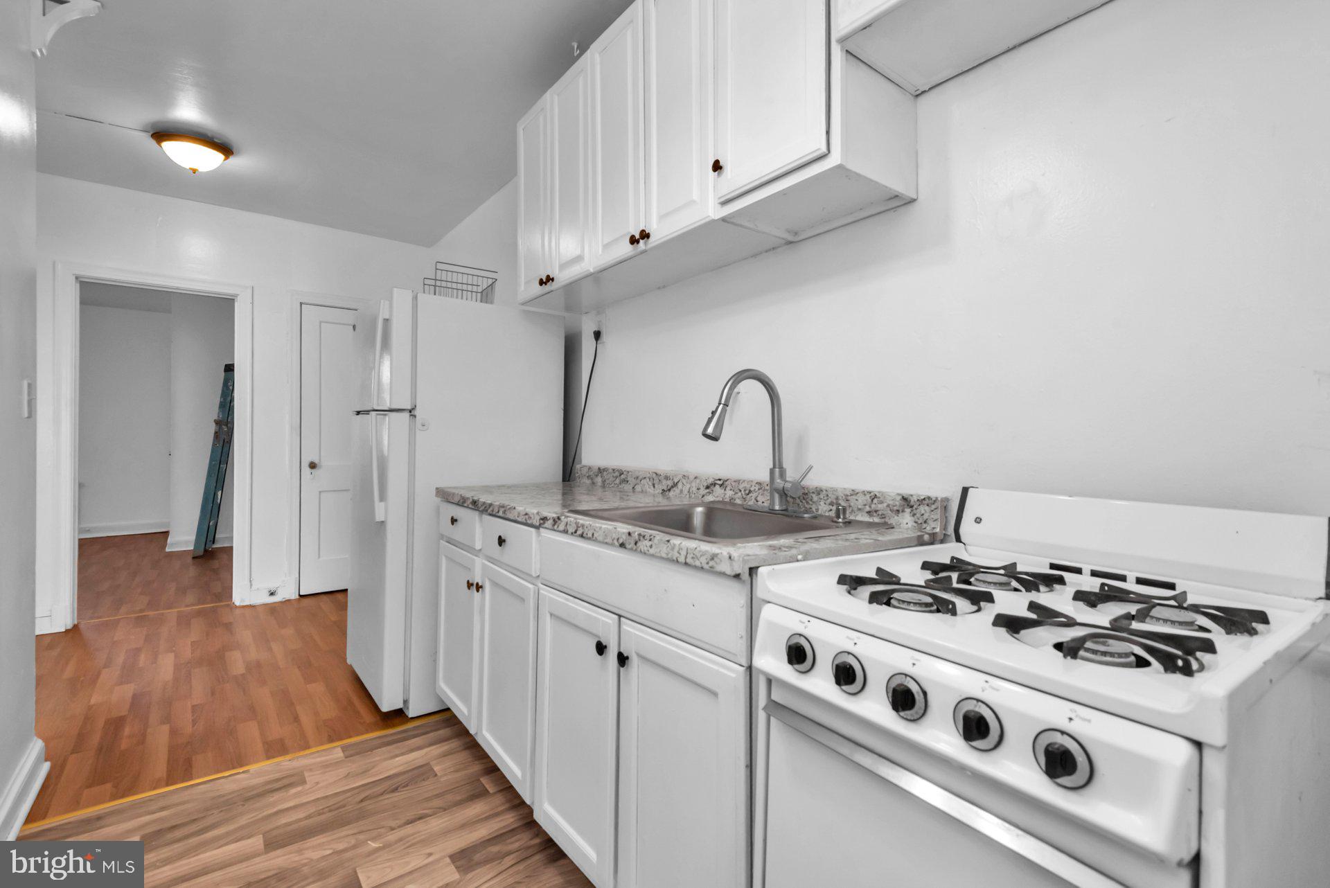 1016 Irving Street Northwest Washington, DC 20010 - Photo 10 of 37 a white stove top oven sitting inside of a kitchen