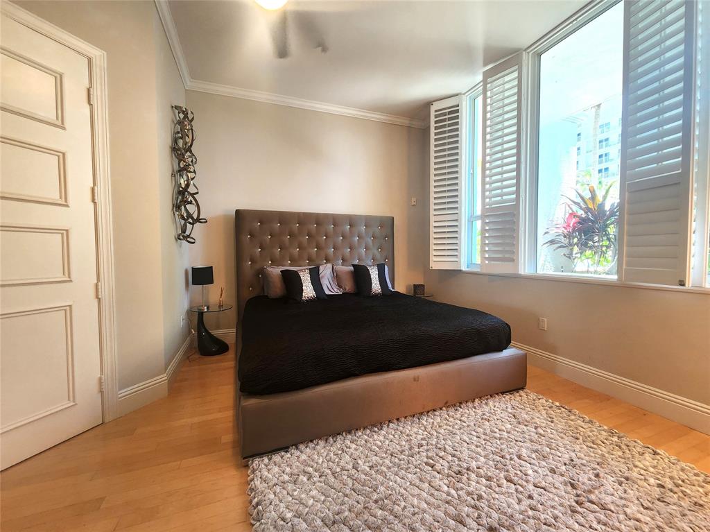 701 Southeast 21st Avenue, Unit 103 Deerfield Beach, FL 33441 - Photo 14 of 31 a bedroom with a bed and window