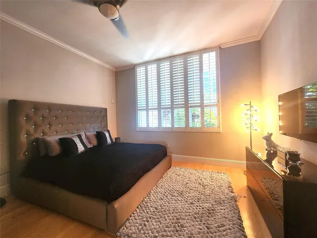 a living room with a bed furniture and a flat screen tv