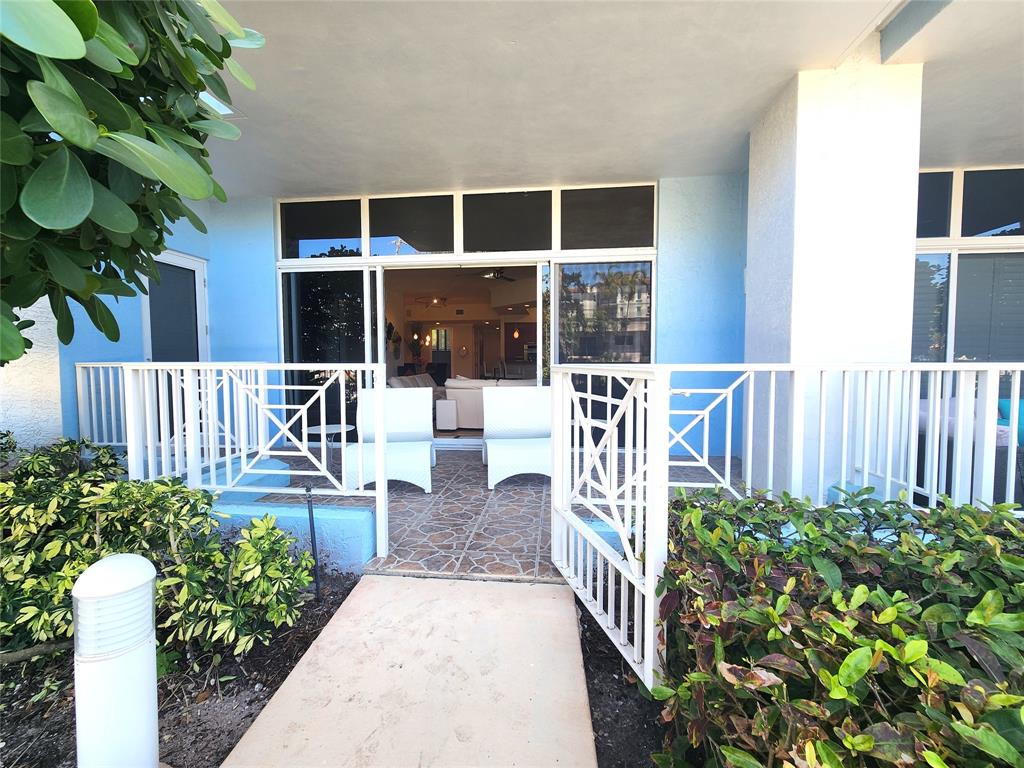 701 Southeast 21st Avenue, Unit 103 Deerfield Beach, FL 33441 - Photo 20 of 31 a view of a porch with chairs and potted plants